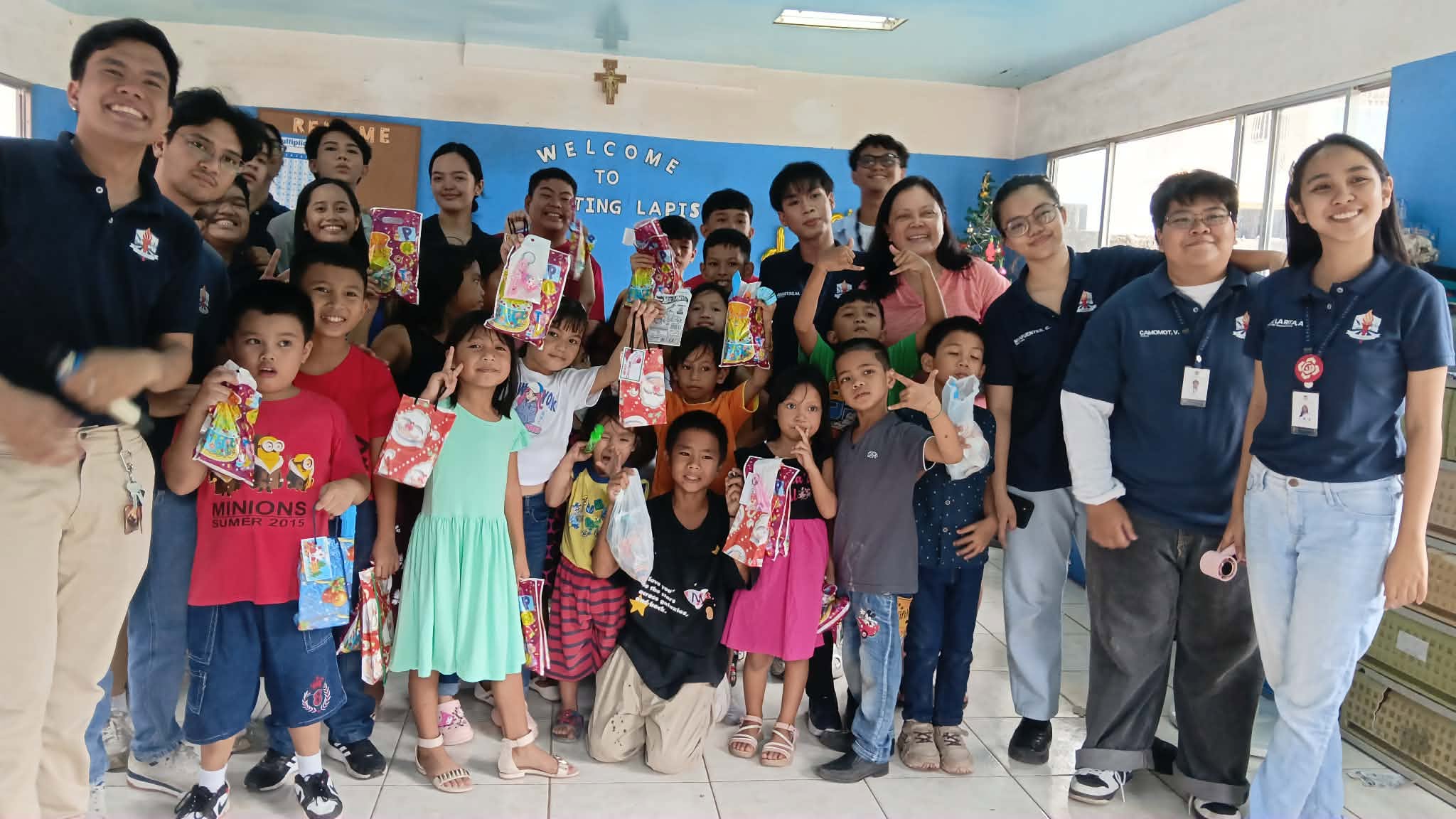 Xavier University student volunteers with children at the center